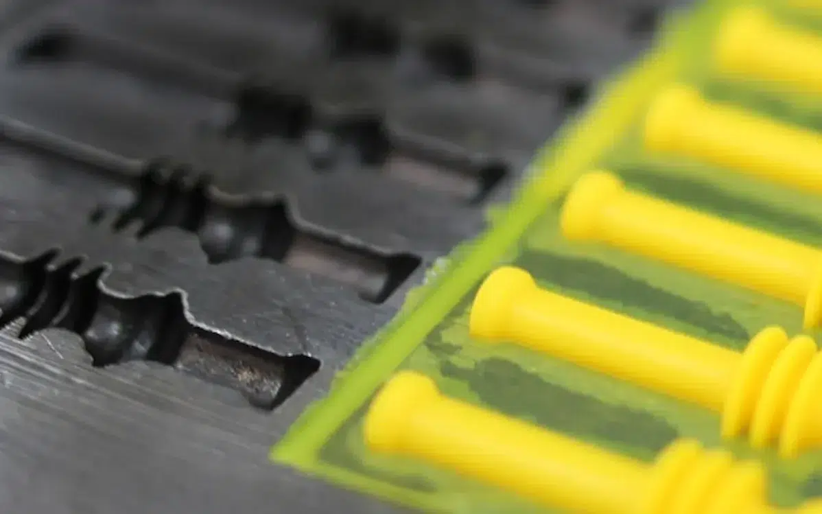 HangOn product pictured with a black and yellow mold used for manufacturing processes.